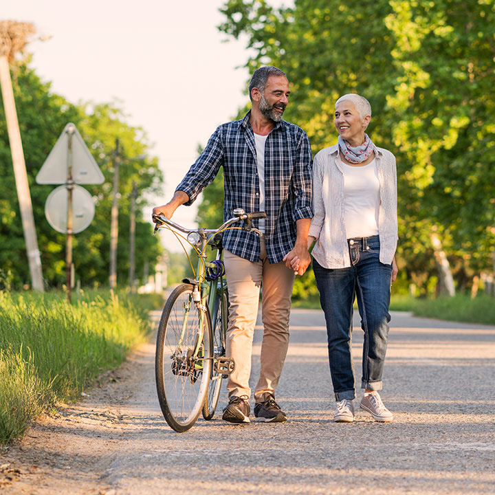 couple walking with bike